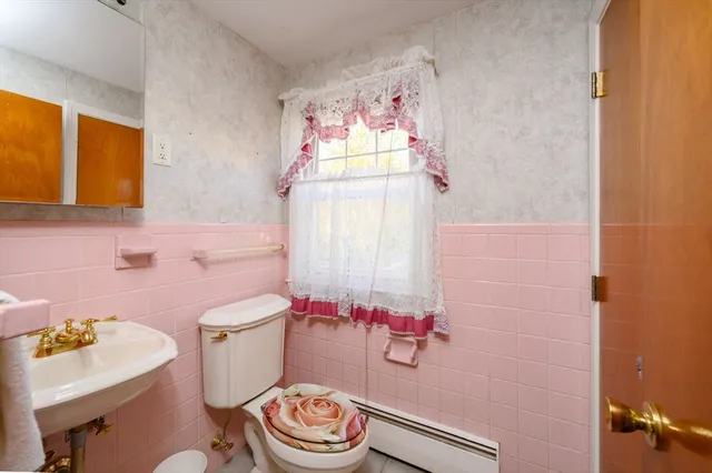 a bathroom with a sink a toilet and a tub