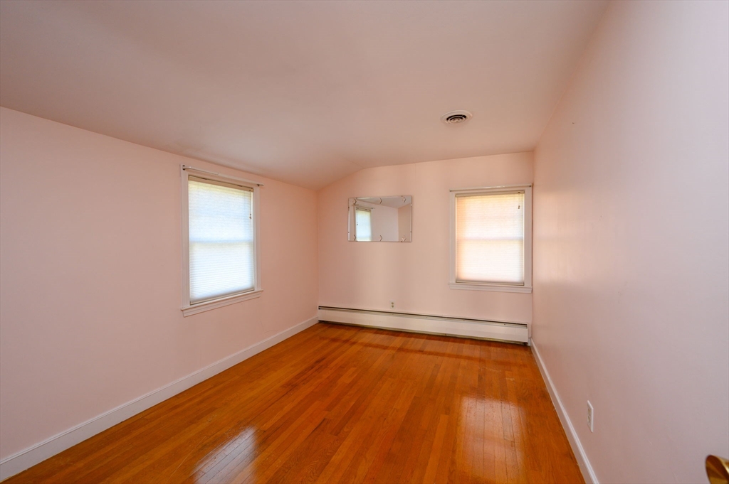 61 Grove Street Braintree, MA 02184 - Photo 18 of 29 an empty room with wooden floor and windows