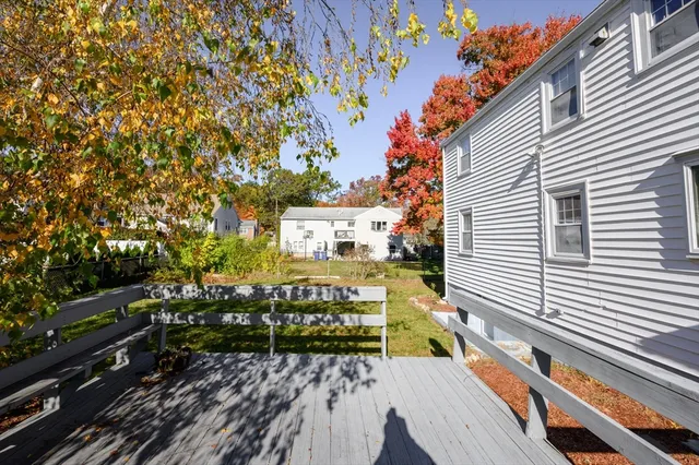 a view of a wooden bench sitting in front of a house