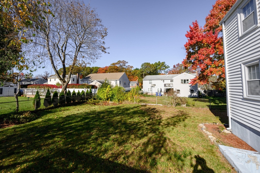 61 Grove Street Braintree, MA 02184 - Photo 25 of 29 a view of a yard with plants and trees