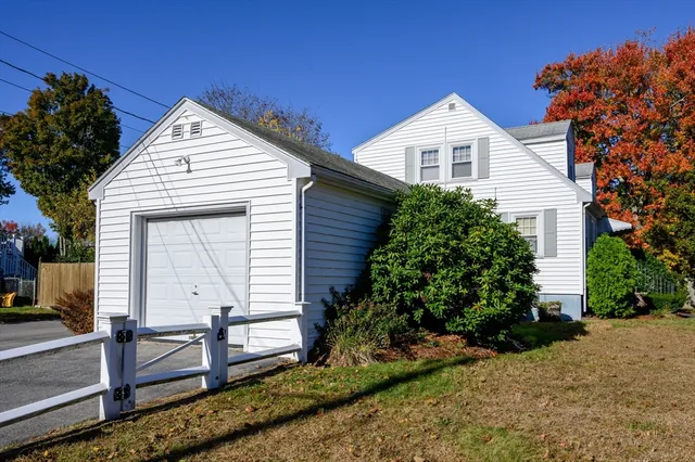 a view of house with backyard and garden
