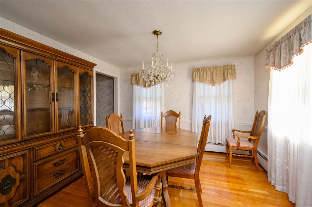 61 Grove Street Braintree, MA 02184 - Photo 9 of 29 a dining room with furniture a chandelier and wooden floor