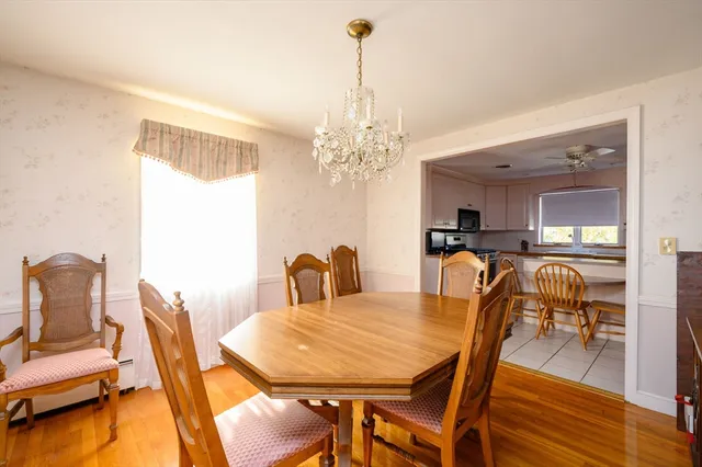 a view of a dining room with furniture wooden floor and chandelier