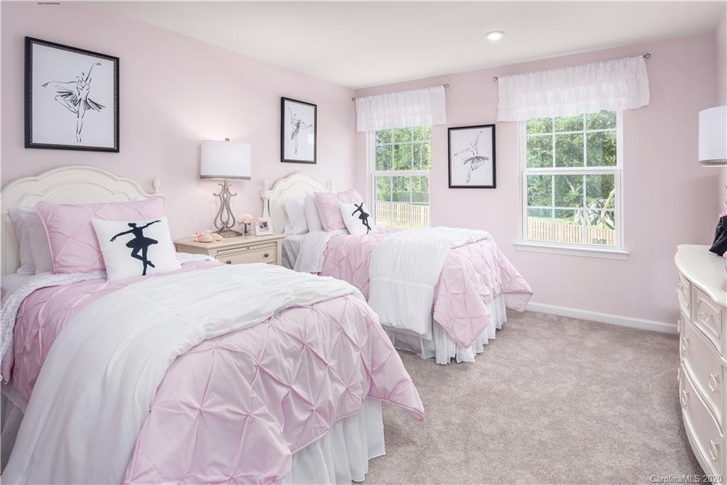 7108 Messina Road, Unit 137 Indian Land, SC 29707 - Photo 9 of 13 a spacious bedroom with two beds and a window