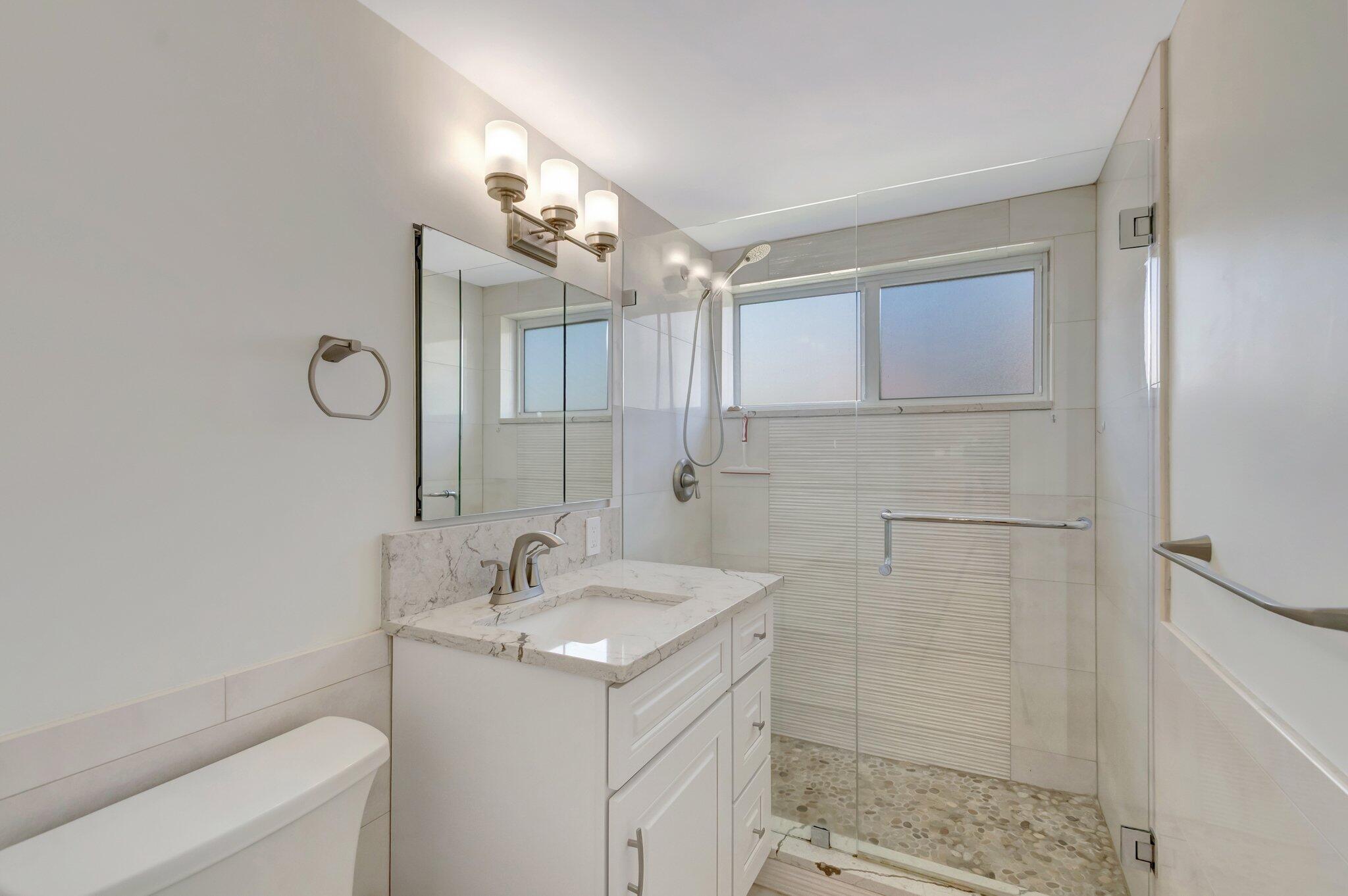 5700 Old Ocean Boulevard, Unit R Ocean Ridge, FL 33435 - Photo 12 of 20 a bathroom with a sink a toilet and shower