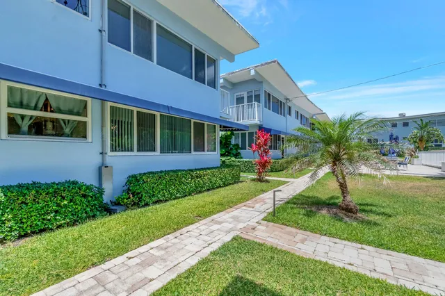 a view of a patio with a table and chairs