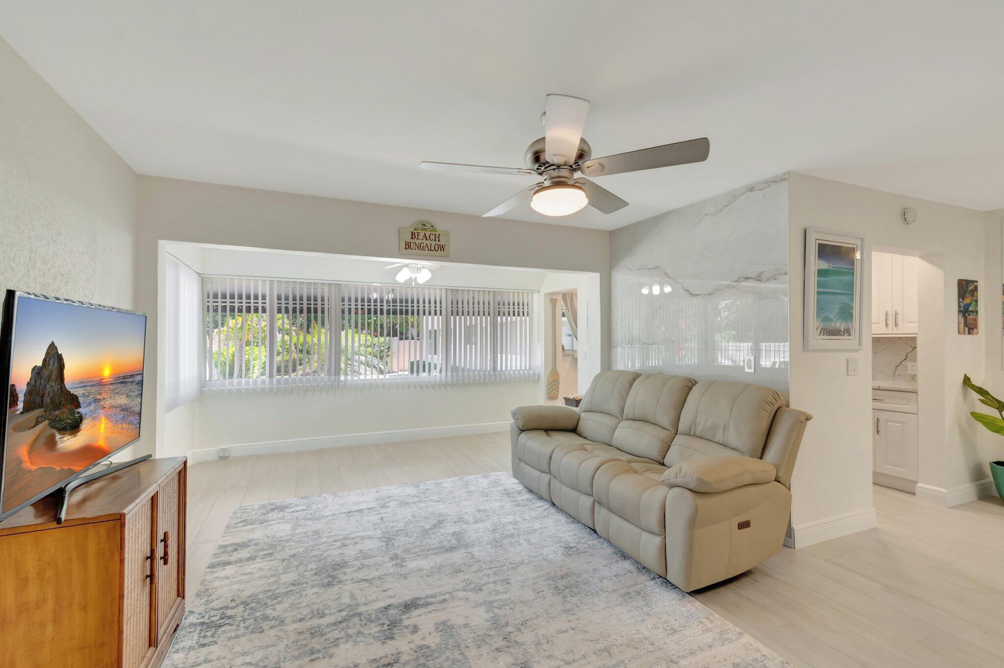 5700 Old Ocean Boulevard, Unit R Ocean Ridge, FL 33435 - Photo 3 of 20 a living room with furniture and a flat screen tv