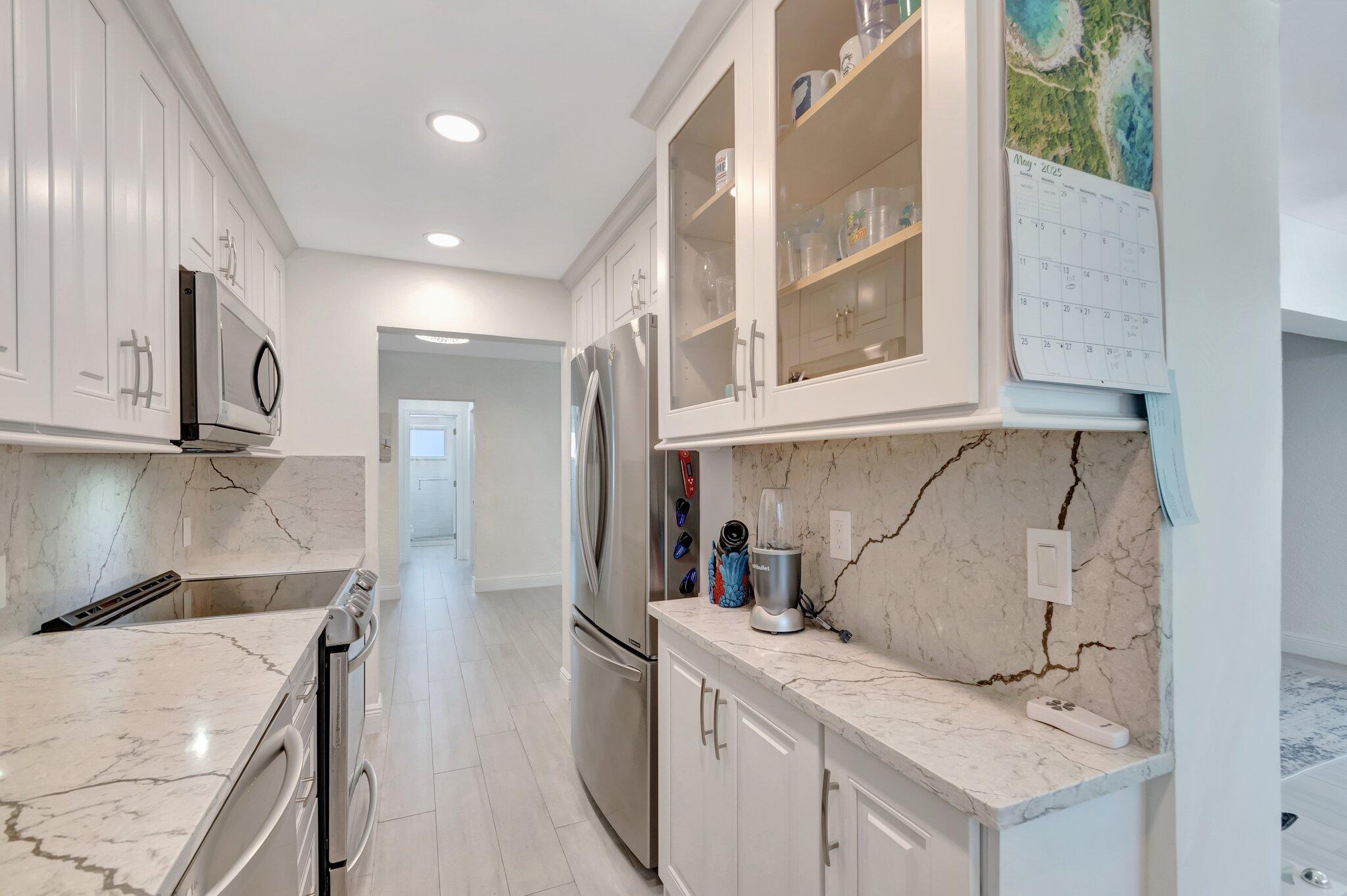 5700 Old Ocean Boulevard, Unit R Ocean Ridge, FL 33435 - Photo 4 of 20 a kitchen with a sink stove and refrigerator