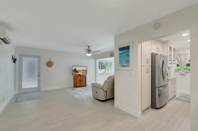 a view of a livingroom with furniture and a hallway