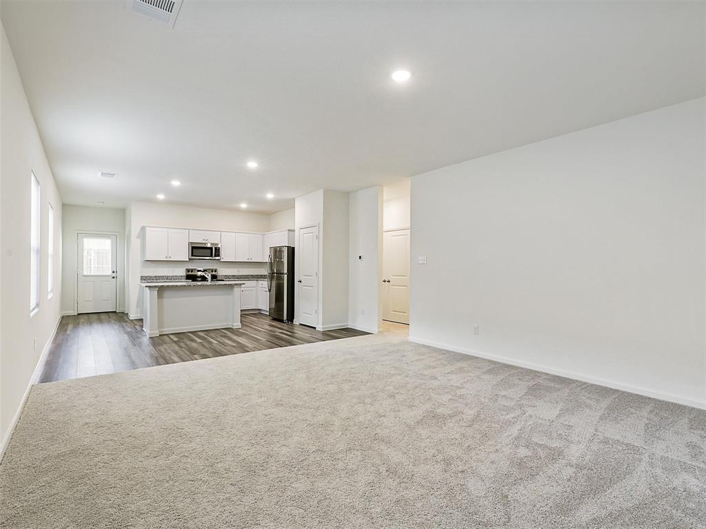 4510 Winecup Road Melissa, TX 75454 - Photo 5 of 22 Spacious open-concept living area featuring light-toned carpeting and recessed lighting