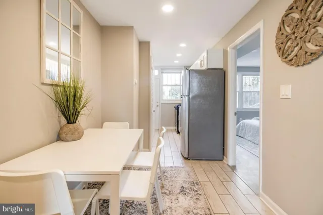 a bedroom with a large bed and a plant