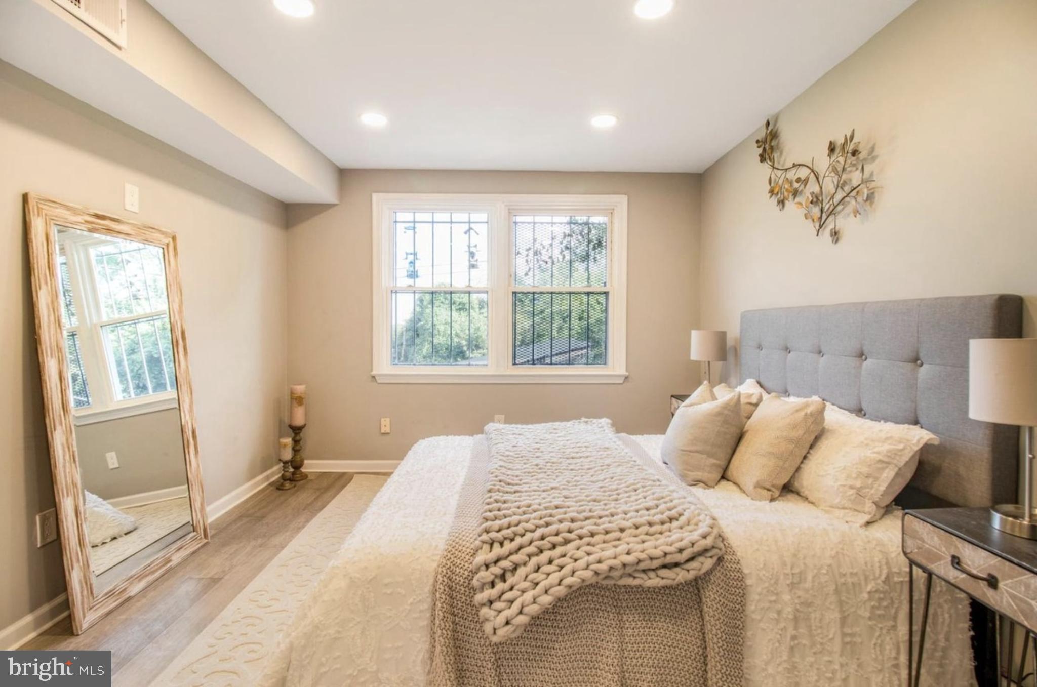 1149 Summit Street Northeast, Unit 2 Washington, DC 20002 - Photo 8 of 14 a bedroom with a bed and a window