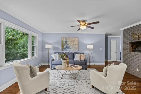 a living room with furniture a lamp and a large window