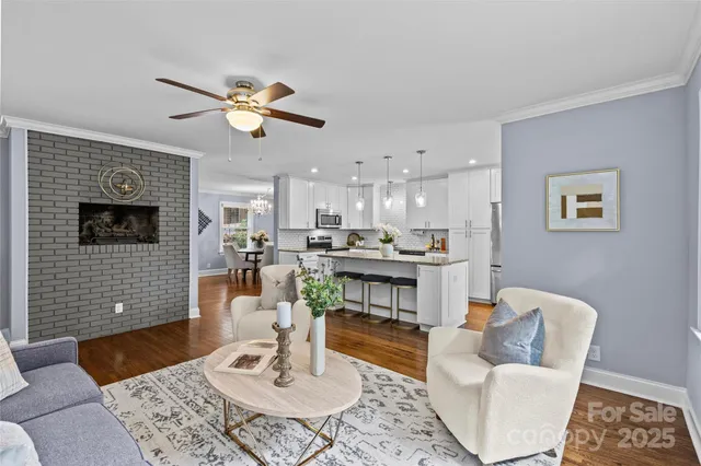 a living room with furniture kitchen view and a table