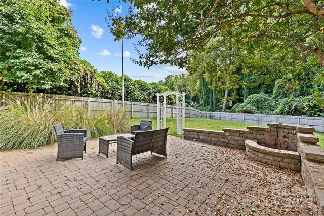 an outdoor sitting area with a lake view