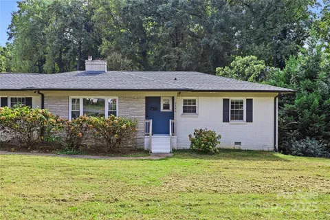 a front view of house with yard and trees