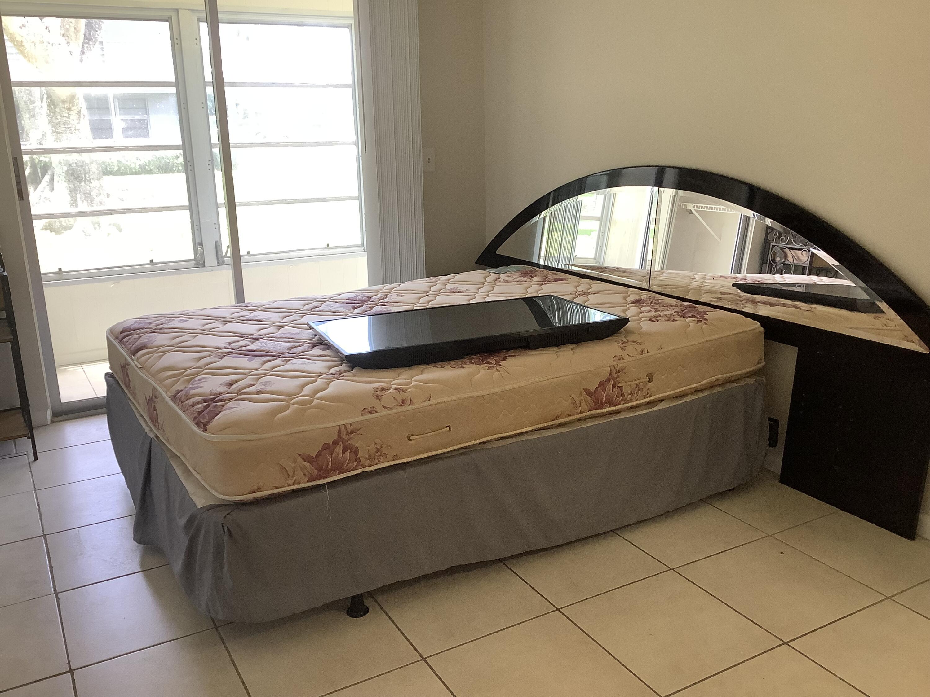 560 Fanshaw North, Unit 560 Boca Raton, FL 33434 - Photo 8 of 26 a bedroom with a bed and a window