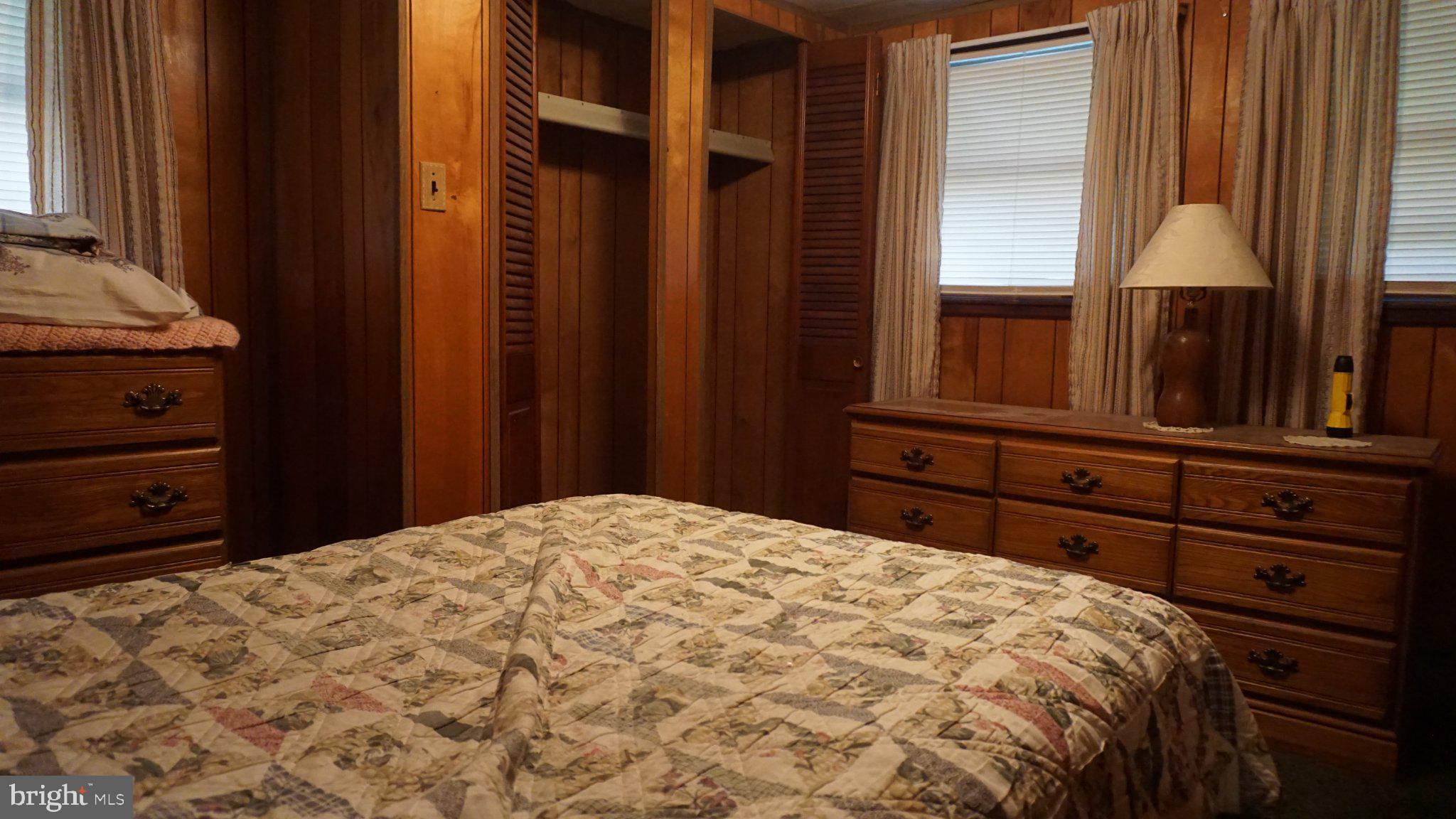 107 Country Lane Buena, NJ 08310 - Photo 5 of 6 a bed sitting in a bedroom next to a window and a mirror