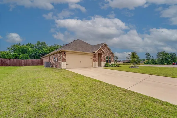 a front view of house with yard and garage