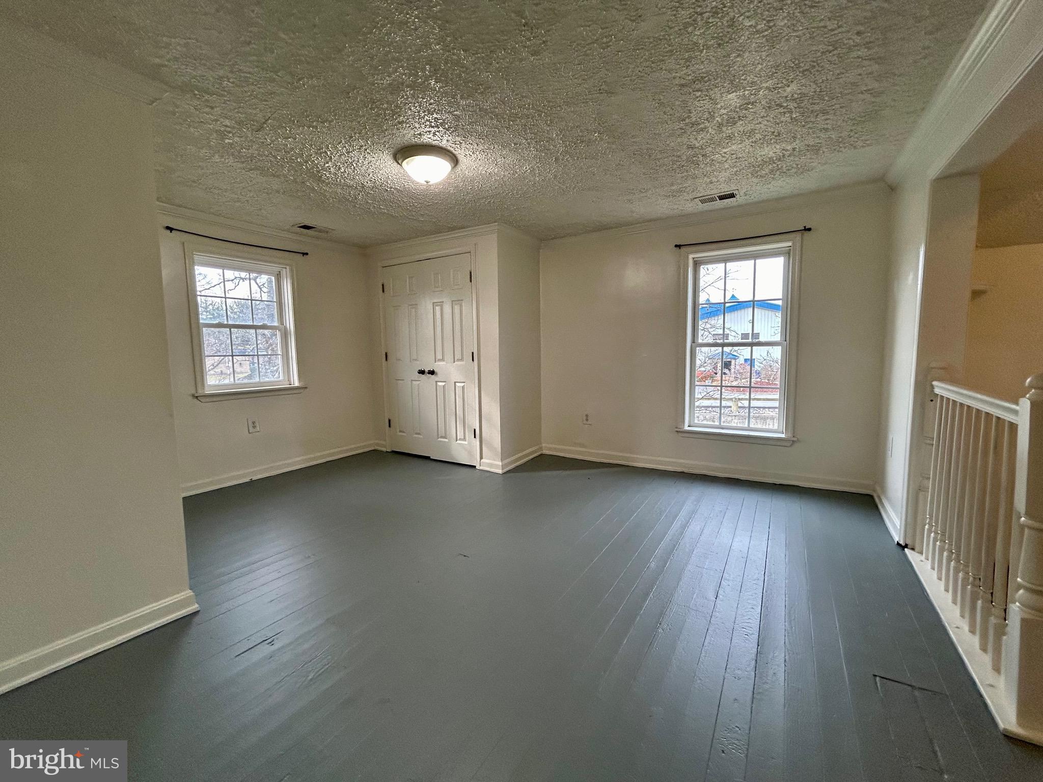2266 Henshaw Road Inwood, WV 25428 - Photo 18 of 25 an empty room with wooden floor and windows