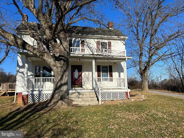a view of a house with a small yard and wooden fence