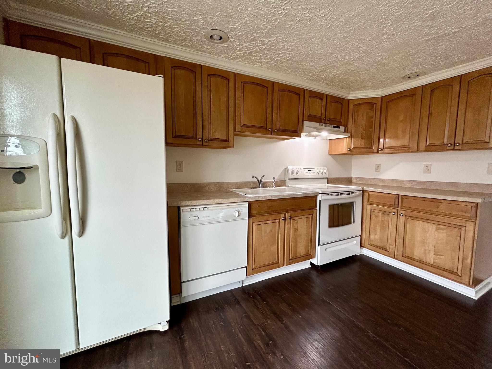 2266 Henshaw Road Inwood, WV 25428 - Photo 25 of 25 a kitchen with a sink a refrigerator and cabinets