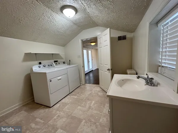 a utility room with a sink a washer and dryer