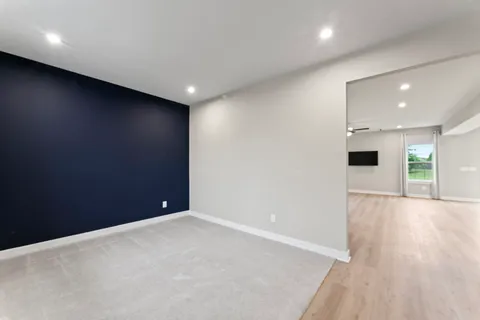 an empty room with wooden floor