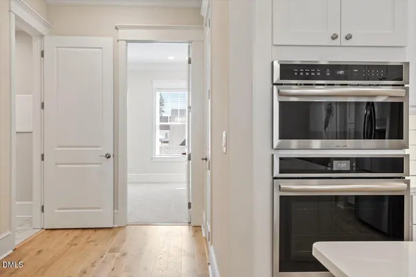 a kitchen with granite countertop white cabinets and stainless steel appliances