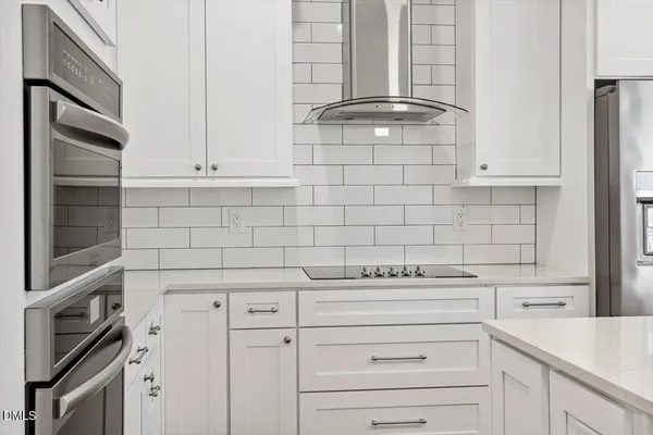 a kitchen with appliances a sink and cabinets