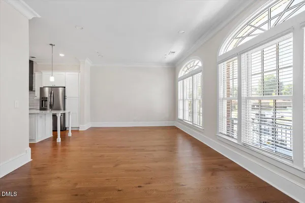 a living room with furniture a rug and kitchen view