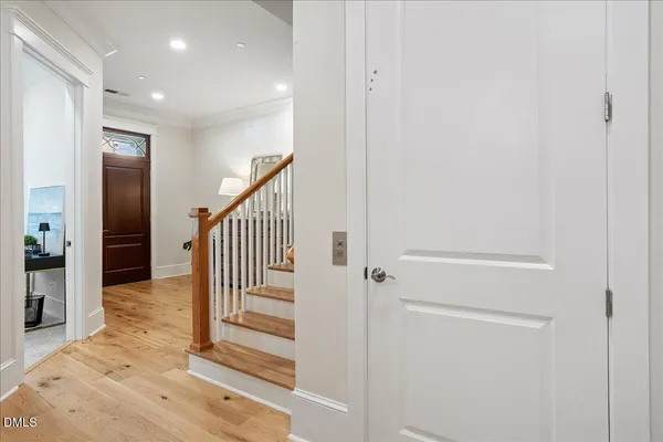 a view of a hallway with wooden floor and entryway