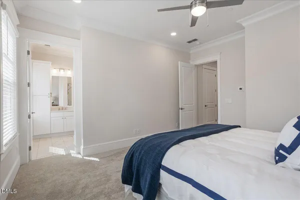 a spacious bedroom with a bed and a window