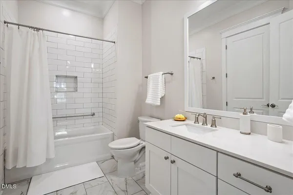 a kitchen with kitchen island granite countertop a sink a counter space appliances and cabinets