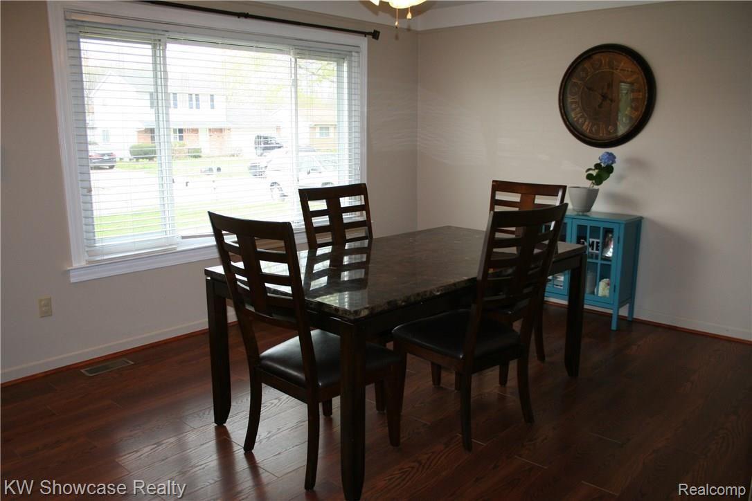 43824 Proctor Road Canton, MI 48188 - Photo 2 of 12 Living room being used as dining room. Beautiful floors and natural light.