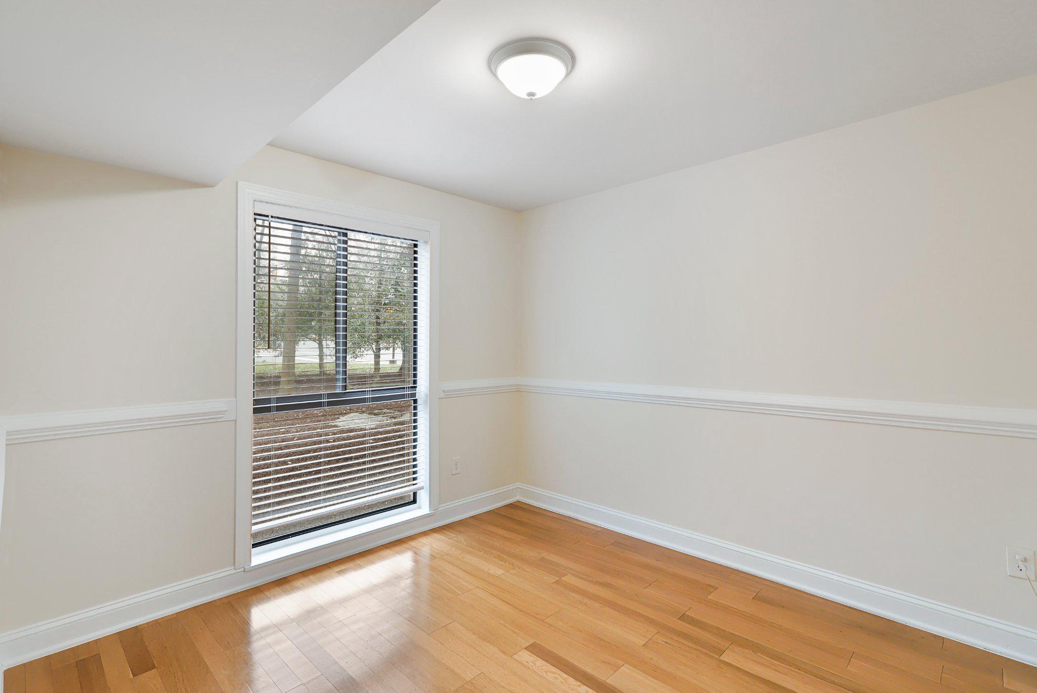2037 Royal Fern Court, Unit 47/2C Reston, VA 20191 - Photo 15 of 48 an empty room with wooden floor and windows
