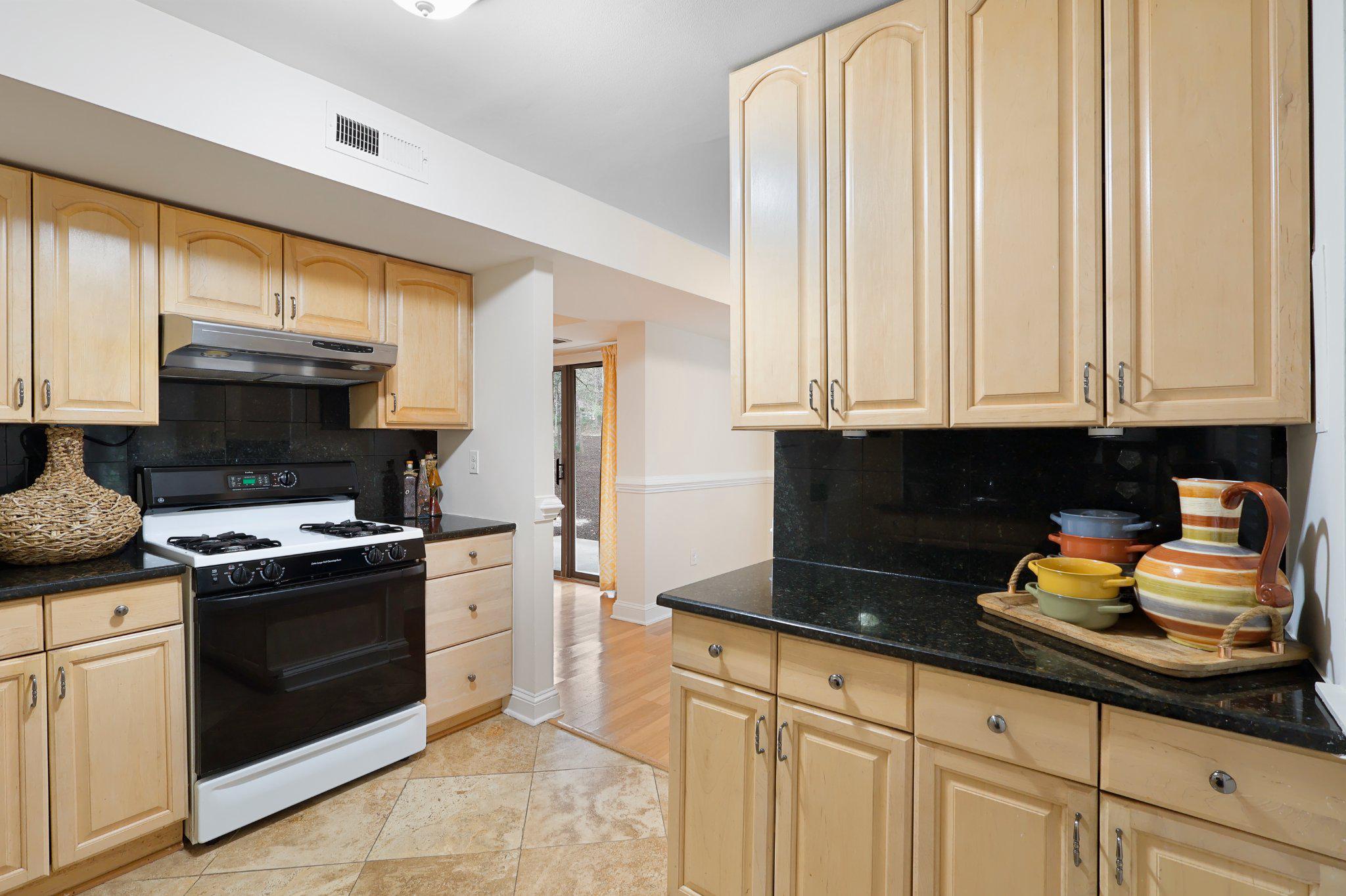 2037 Royal Fern Court, Unit 47/2C Reston, VA 20191 - Photo 17 of 48 a kitchen with stainless steel appliances granite countertop a stove a sink and a refrigerator