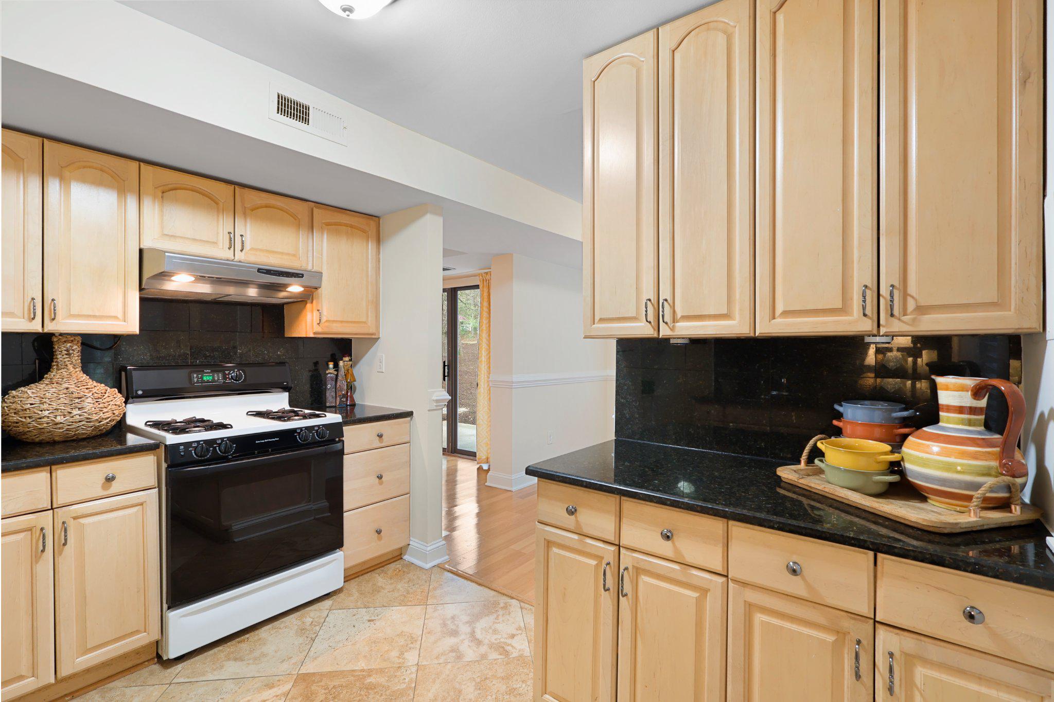 2037 Royal Fern Court, Unit 47/2C Reston, VA 20191 - Photo 19 of 48 a kitchen with stainless steel appliances granite countertop a stove a sink and white cabinets