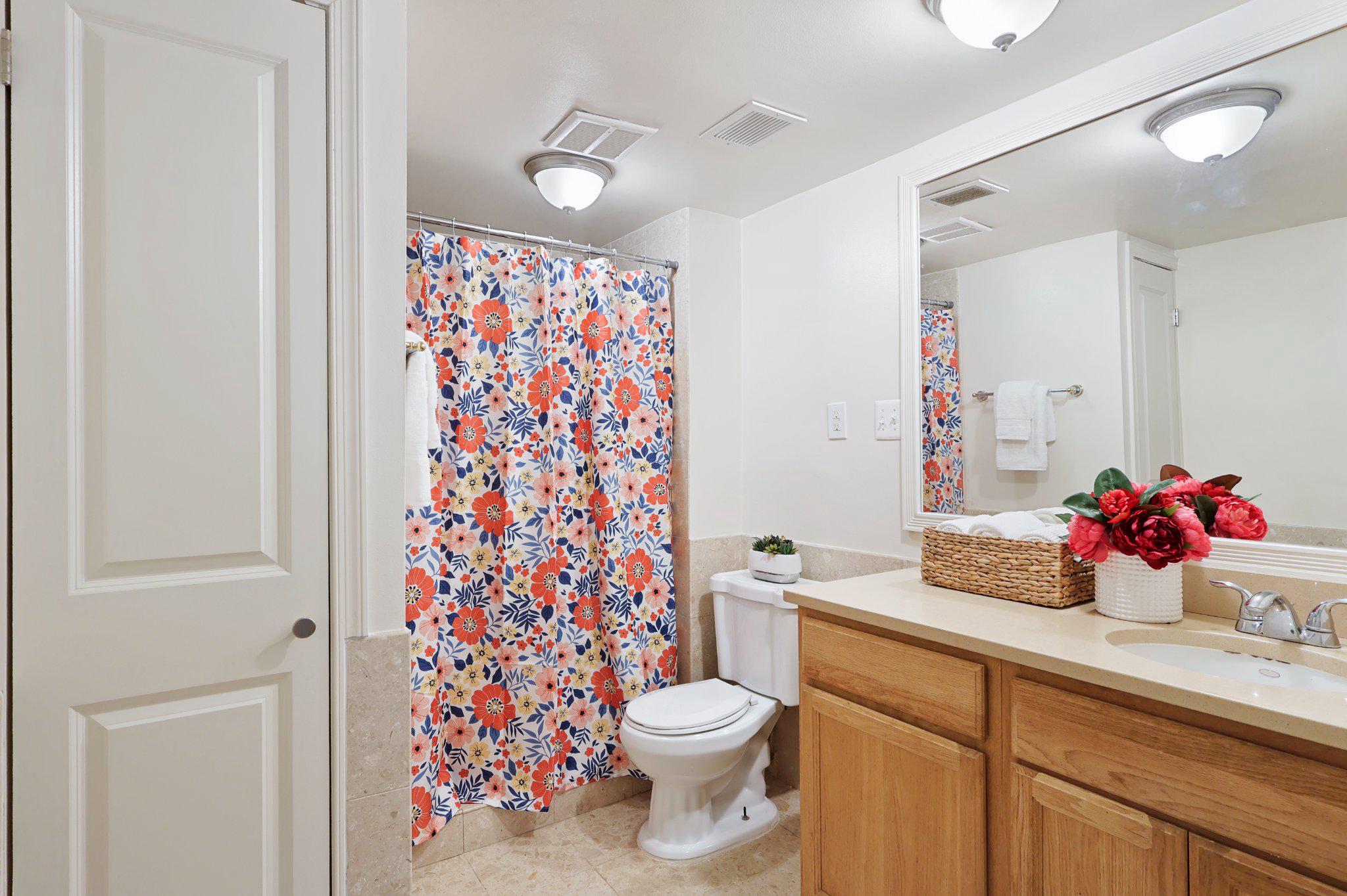 2037 Royal Fern Court, Unit 47/2C Reston, VA 20191 - Photo 26 of 48 a bathroom with a sink a toilet and shower curtain