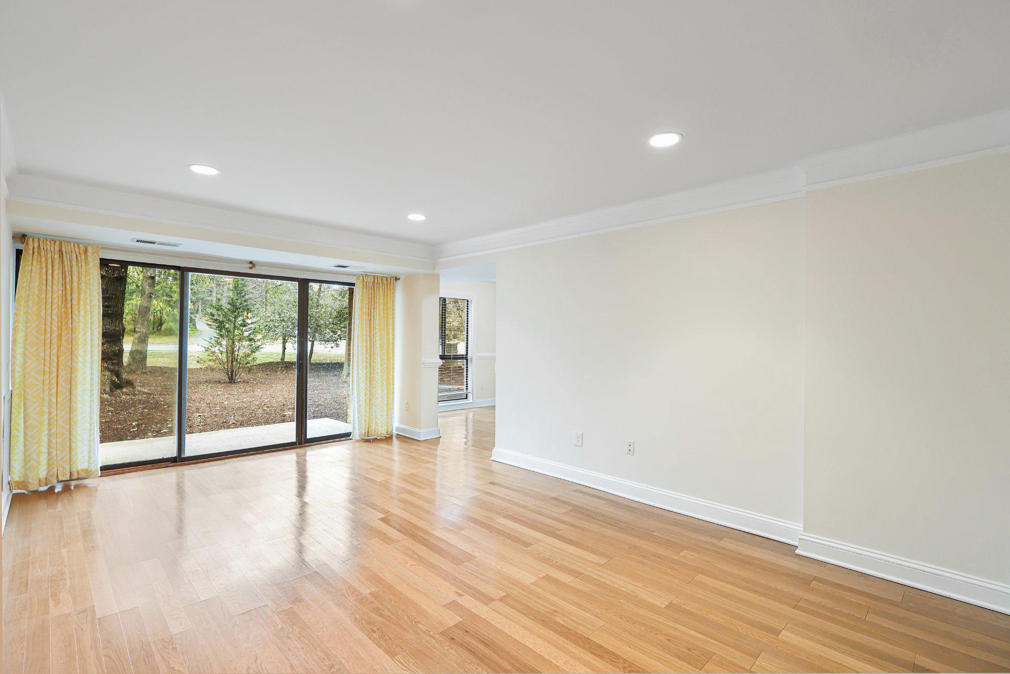 2037 Royal Fern Court, Unit 47/2C Reston, VA 20191 - Photo 10 of 48 a view of an empty room with wooden floor and a window