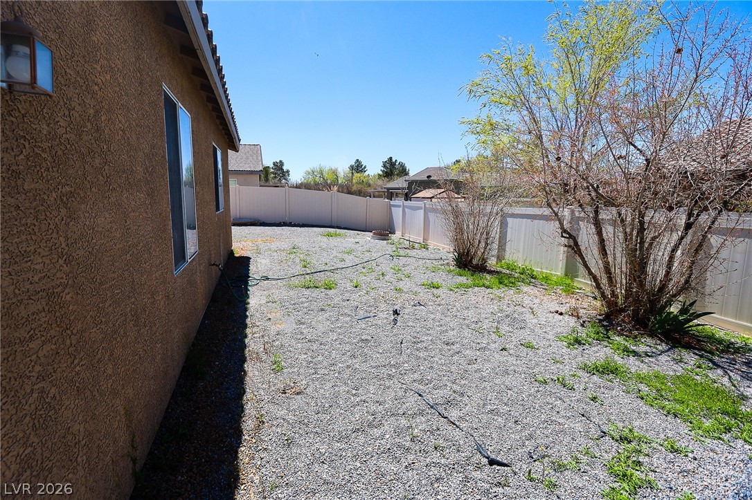 6472 Centennial Road Pahrump, NV 89048 - Photo 18 of 29 A spacious backyard awaits, ready for personalization and offering ample room for outdoor activities.