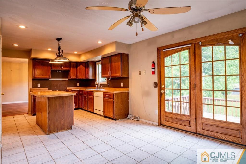 207 Fresh Ponds Road Monroe Township, NJ 08831 - Photo 13 of 25 a kitchen with stainless steel appliances kitchen island granite countertop a stove a sink and a refrigerator