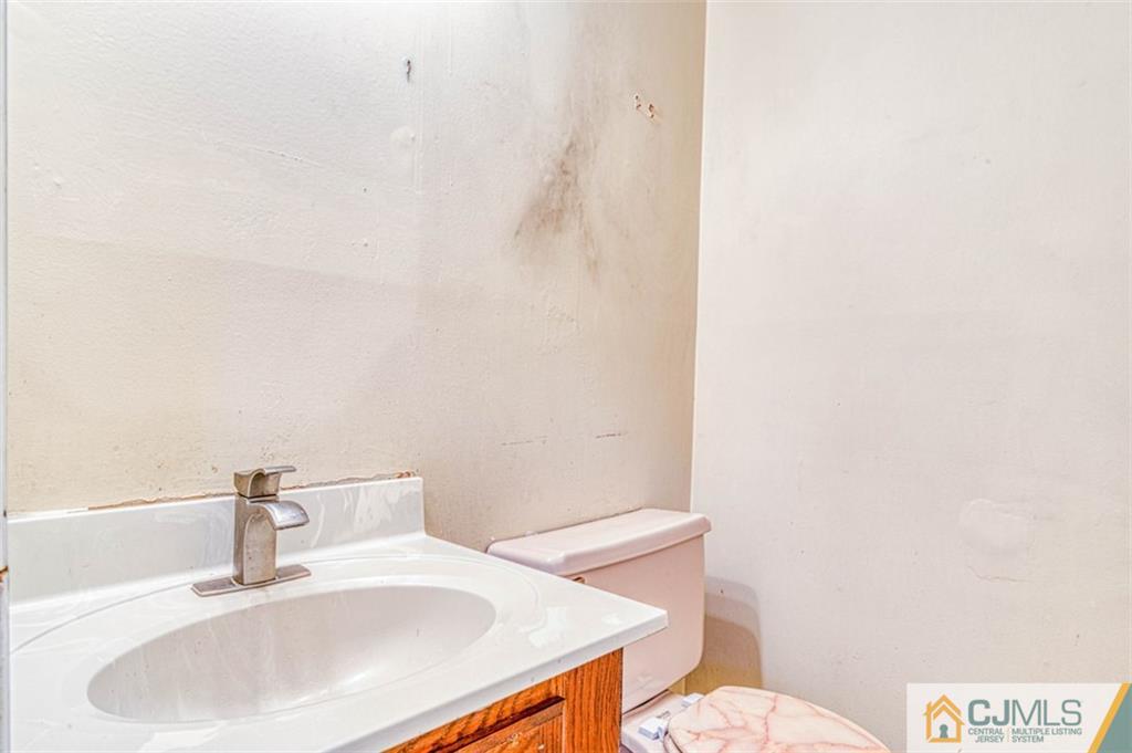 207 Fresh Ponds Road Monroe Township, NJ 08831 - Photo 14 of 25 a bathroom with a sink a toilet and mirror