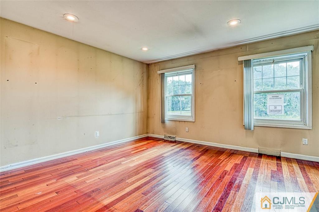 207 Fresh Ponds Road Monroe Township, NJ 08831 - Photo 15 of 25 a view of empty room with wooden floor and fan