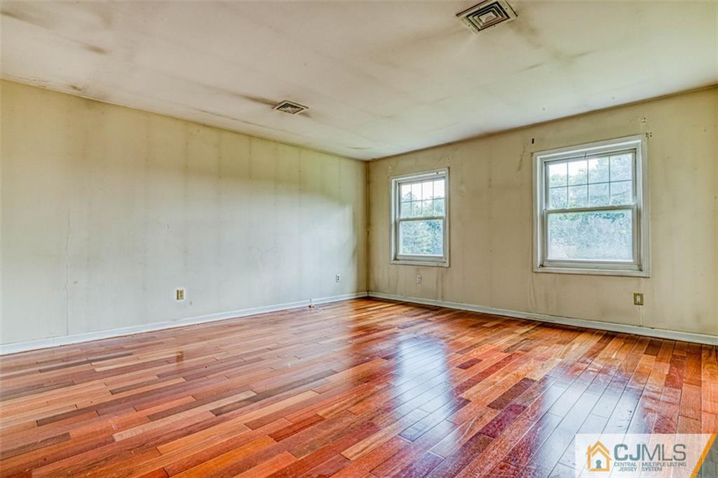 207 Fresh Ponds Road Monroe Township, NJ 08831 - Photo 18 of 25 wooden floor in an empty room with a window