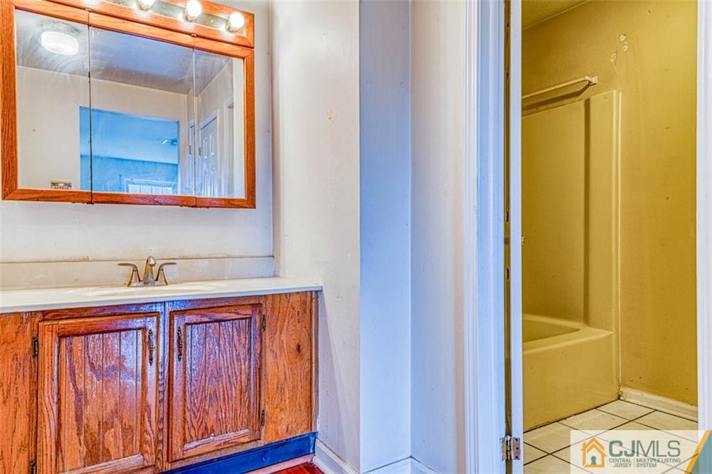 207 Fresh Ponds Road Monroe Township, NJ 08831 - Photo 19 of 25 a bathroom with a sink and a mirror