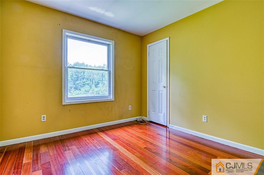 207 Fresh Ponds Road Monroe Township, NJ 08831 - Photo 20 of 25 a view of a room with wooden floor and a window