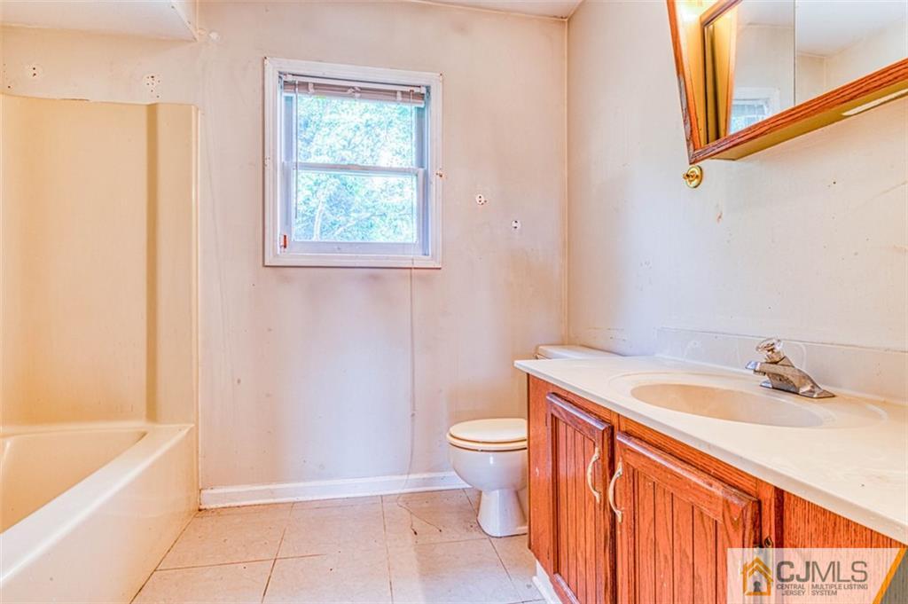 207 Fresh Ponds Road Monroe Township, NJ 08831 - Photo 21 of 25 a bathroom with a sink a toilet and bathtub
