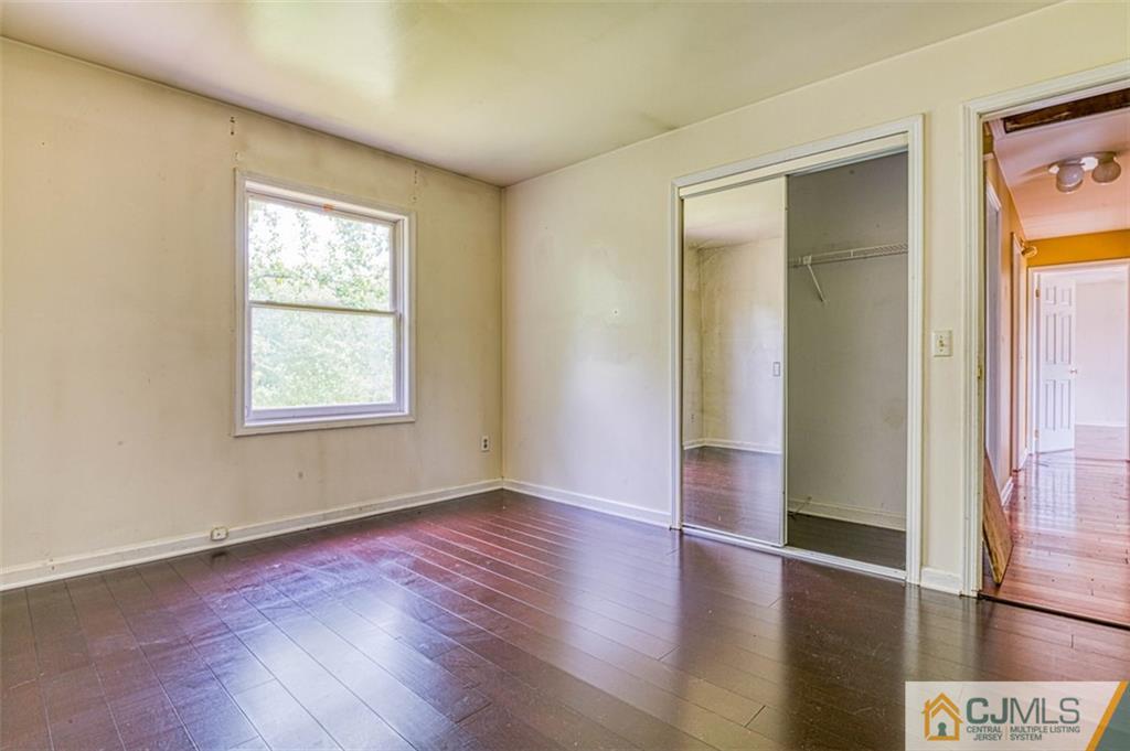 207 Fresh Ponds Road Monroe Township, NJ 08831 - Photo 25 of 25 an empty room with wooden floor and windows