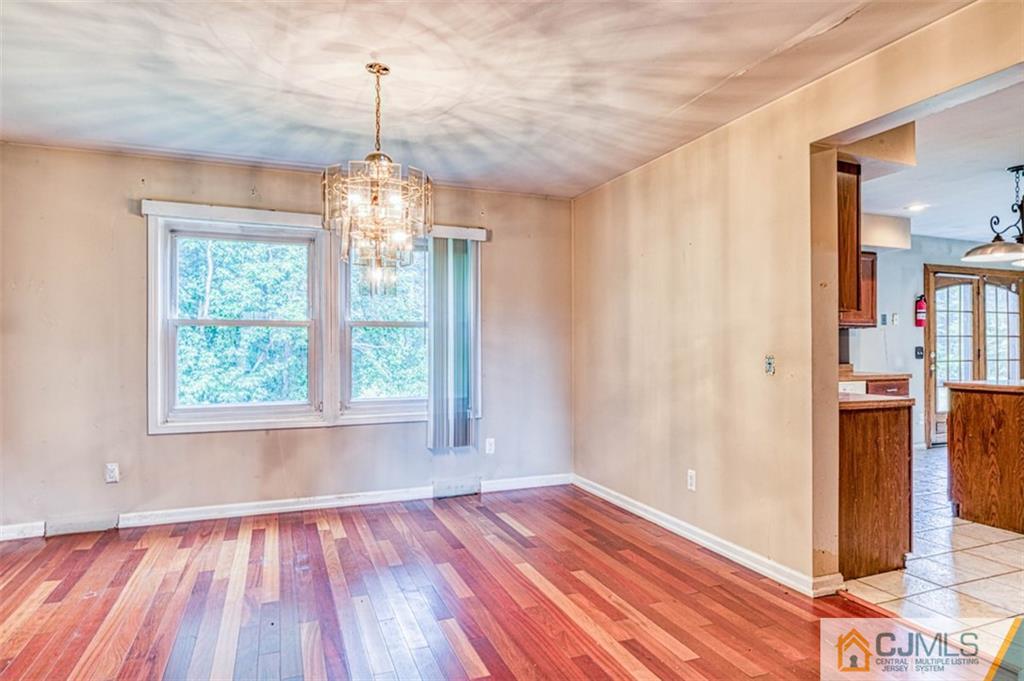 207 Fresh Ponds Road Monroe Township, NJ 08831 - Photo 9 of 25 a view of empty room with wooden floor and fan